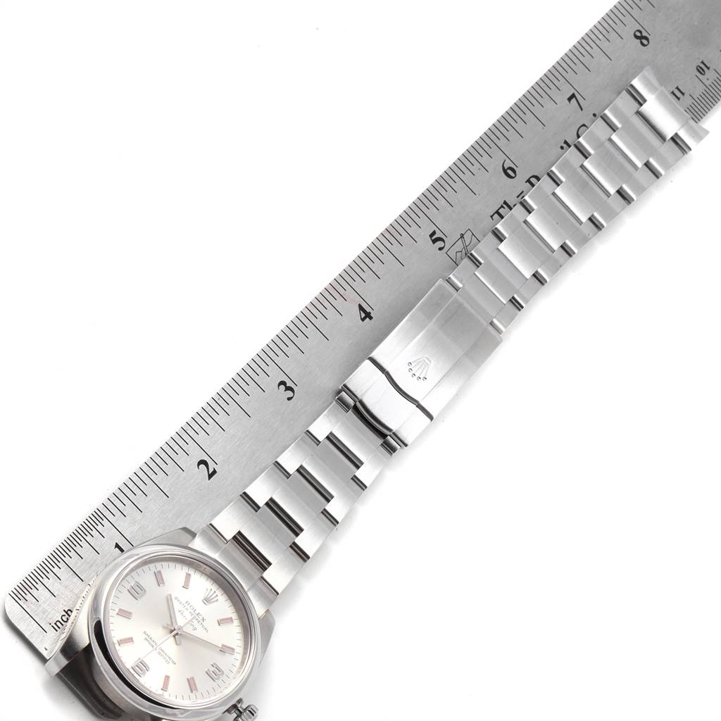 The Rolex 114200 Stainless Steel Silver Dial 114200 Stainless Steel Silver Dial Air King Silver Dial Pink Baton Markers Unisex Watch 114200 is shown laid flat with a metal ruler for measurement.