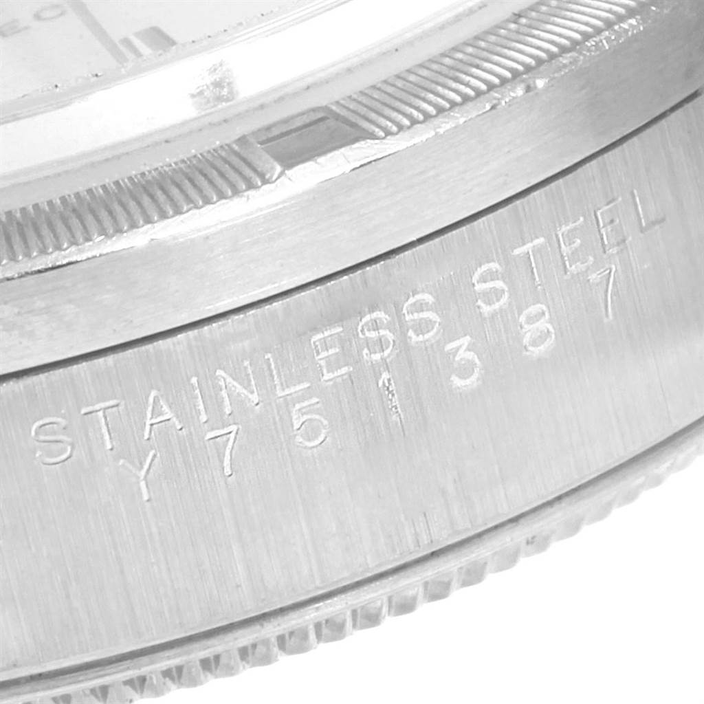 The image shows a close-up of the side of an Air-King model Rolex watch, focusing on its stainless steel case with engraved writing.