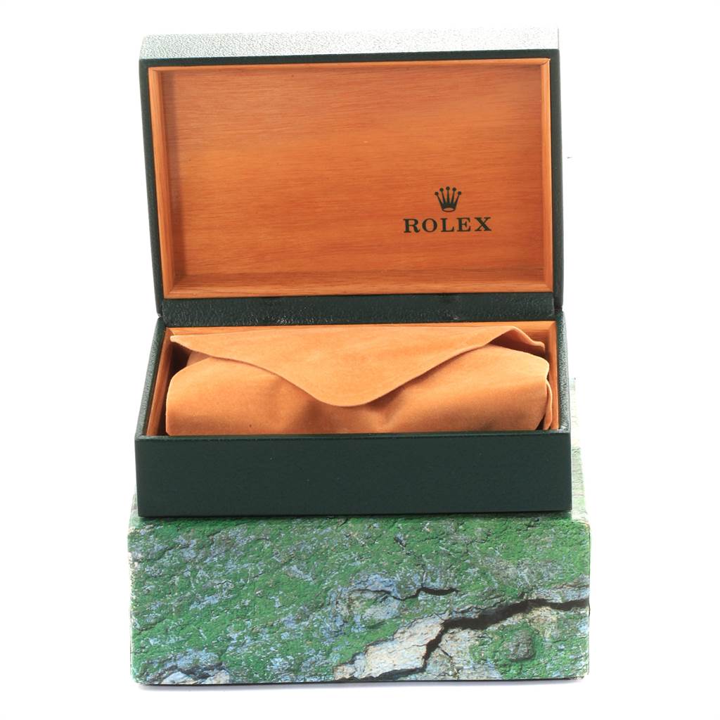 This image shows an open Rolex Air-King 14010 Men's Stainless Steel Silver Dial 14010 Men's Stainless Steel Silver Dial watch box with the watch wrapped in a tan cloth inside.