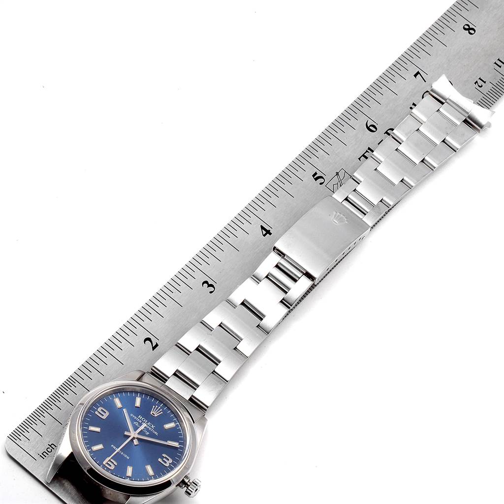 The image shows a Rolex Air-King 14000 Men's Stainless Steel Blue Dial 14000 Men's Stainless Steel Blue Dial watch laid flat from a top-down angle alongside a ruler, highlighting its face and bracelet.