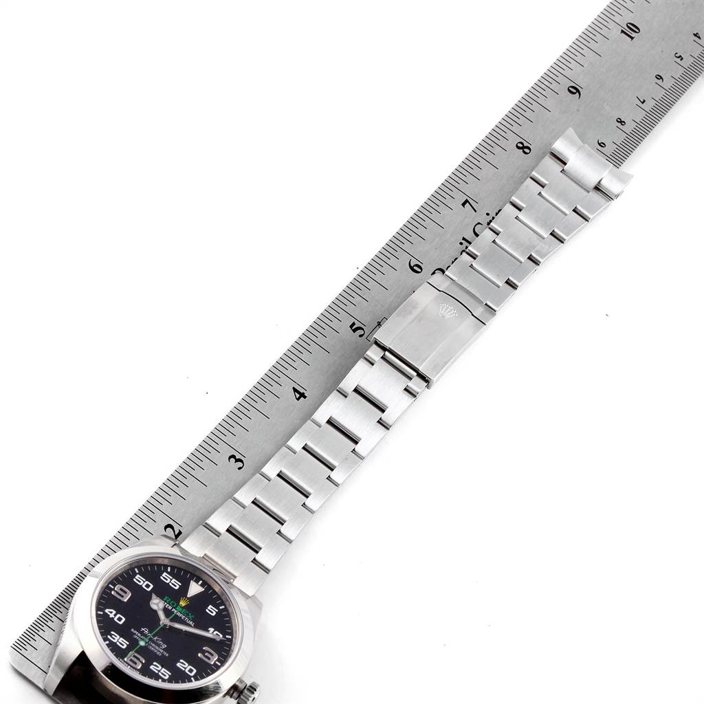 The image shows a Rolex Air-King 116900 Men's Stainless Steel Black Dial 116900 Men's Stainless Steel Black Dial model watch laid flat with its bracelet extended alongside a ruler.