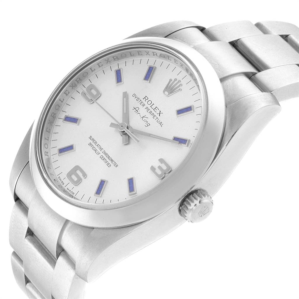 The Rolex Air-King 114200 Men's Stainless Steel Silver Dial 114200 Men's Stainless Steel Silver Dial watch is shown from a slightly angled side view, highlighting the face, bezel, crown, and part of the bracelet.