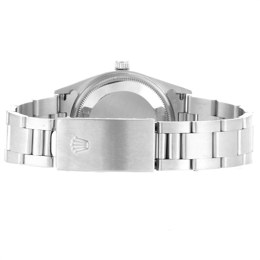 This image shows the back of a Rolex Air-King 14000 Men's Stainless Steel White Dial 14000 Men's Stainless Steel White Dial watch and its stainless steel bracelet and clasp.
