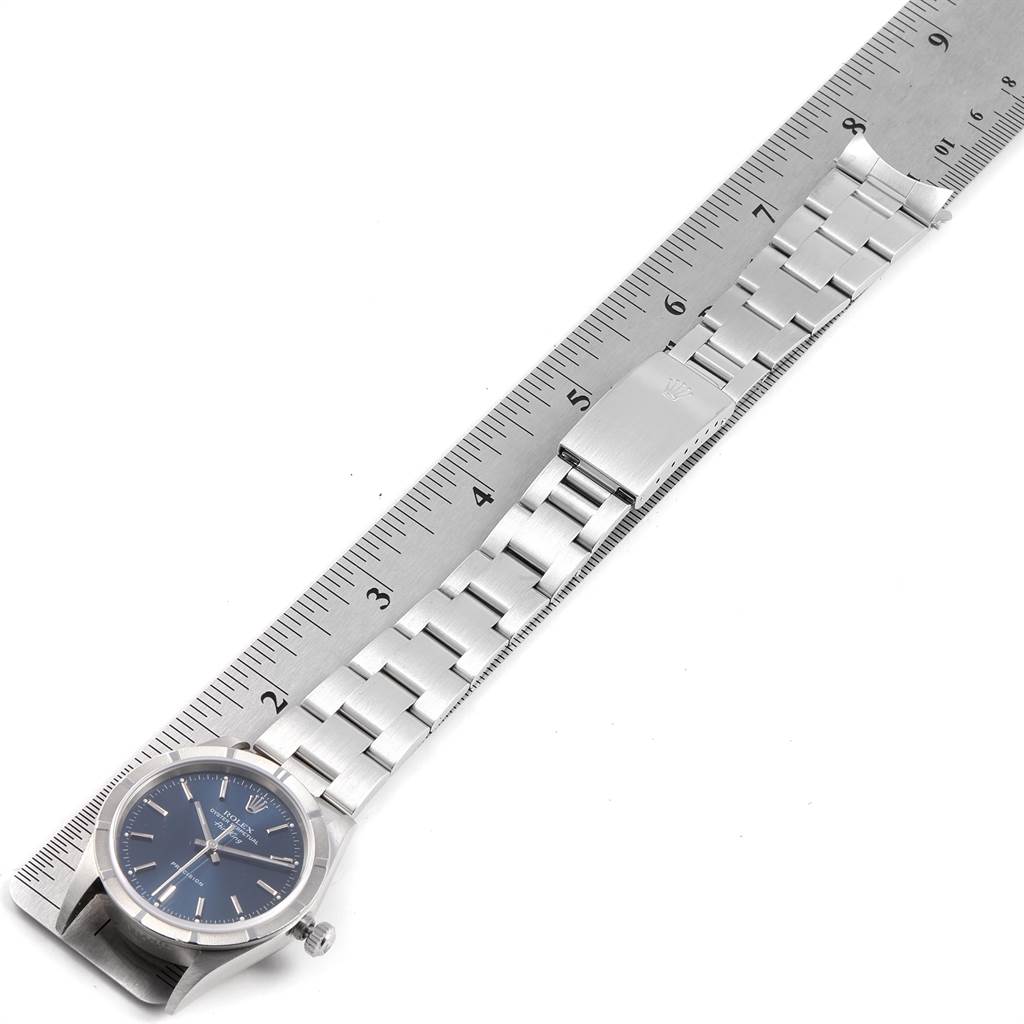 The Rolex Air-King 14010 Men's Stainless Steel Blue Dial 14010 Men's Stainless Steel Blue Dial watch is shown from a top-down angle, displaying the watch face and bracelet against a ruler for size reference.