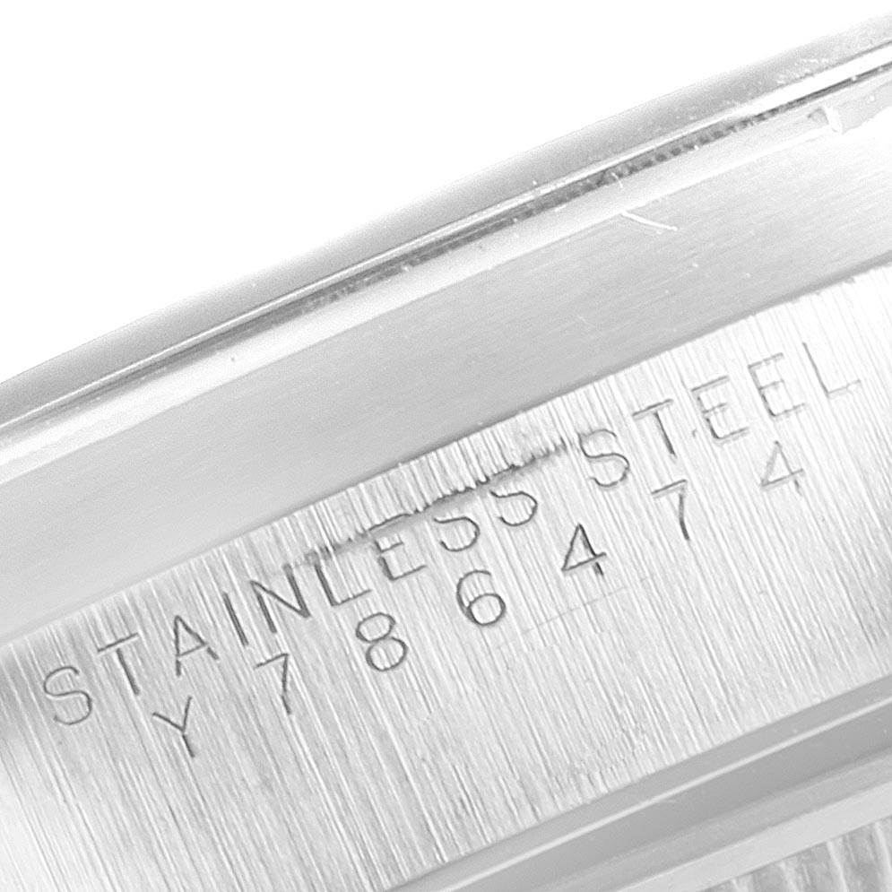 This close-up image shows the engraved serial number and "STAINLESS STEEL" marking on the case of a Rolex Air-King 14010 Men's Stainless Steel Blue Dial 14010 Men's Stainless Steel Blue Dial watch.