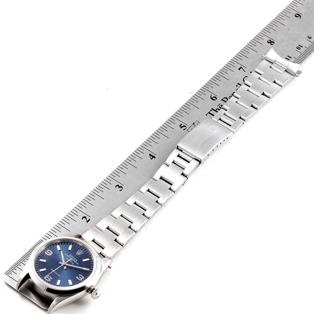 The image shows a side-angle view of a Rolex Air-King 14000 Men's Stainless Steel Blue Dial 14000 Men's Stainless Steel Blue Dial watch and its metal bracelet measured against a ruler.