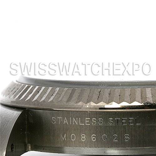 This image shows a close-up of the side of a Rolex Air-King 114234 Stainless Steel Silver Dial 114234 Stainless Steel Silver Dial watch case, displaying the serial number and "STAINLESS STEEL" engraving.