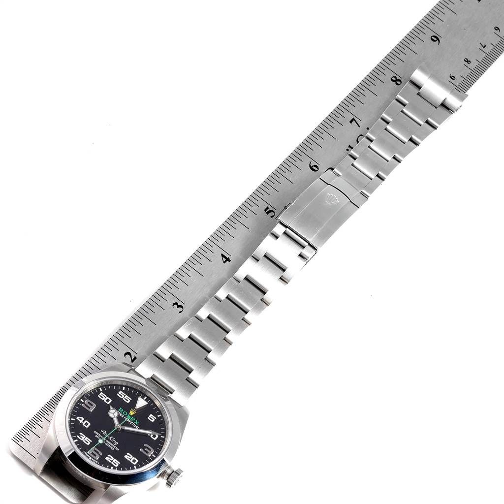 The image shows the Rolex Air-King 116900 Men's Stainless Steel Black Dial 116900 Men's Stainless Steel Black Dial watch placed next to a ruler, revealing the face, case, and bracelet.