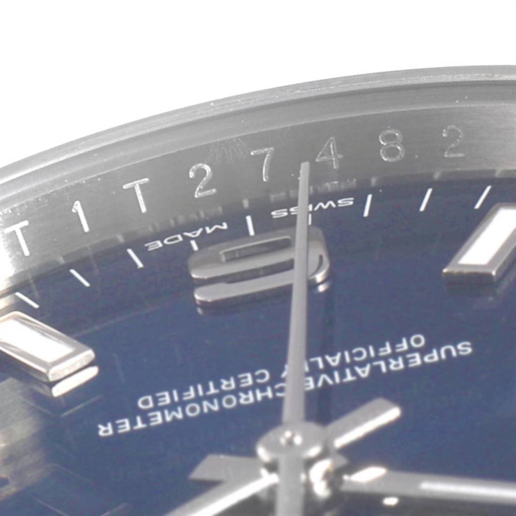 This close-up of the Rolex Air-King 114200 Men's Stainless Steel Blue Dial 114200 Men's Stainless Steel Blue Dial watch shows part of the dial, hands, and some of the bezel markings.