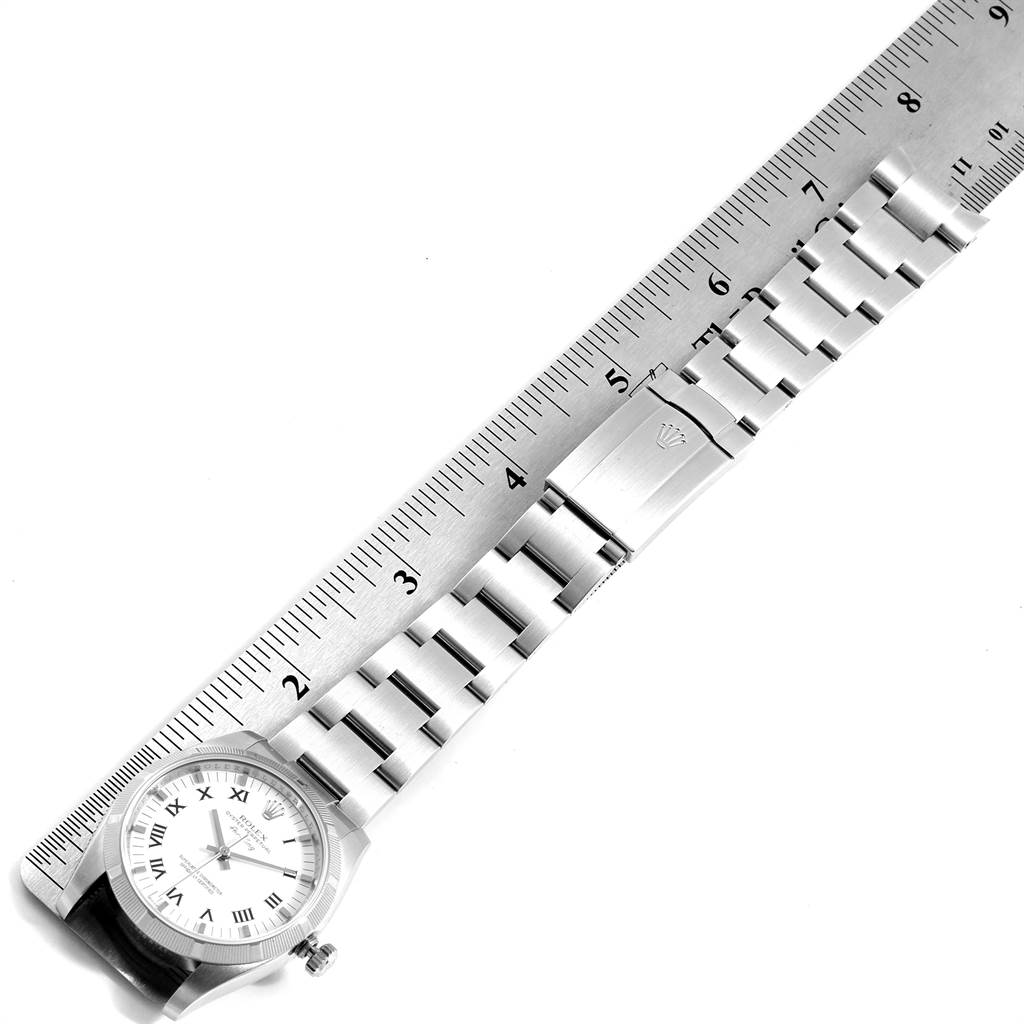 The image displays a Rolex Air-King 114210 Men's Stainless Steel White Dial 114210 Men's Stainless Steel White Dial watch laid flat alongside a ruler, showing the watch face, case, bracelet, and clasp.