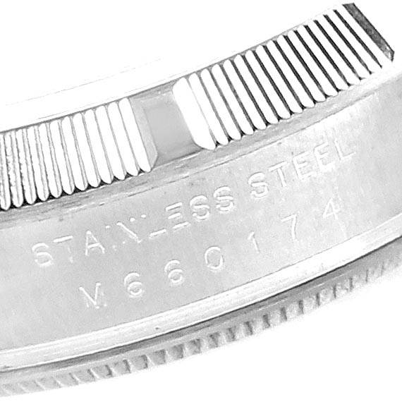 This close-up image of the Rolex Air-King 114210 Men's Stainless Steel White Dial 114210 Men's Stainless Steel White Dial watch shows the ridged bezel and "STAINLESS STEEL" with the model number engraved underneath.