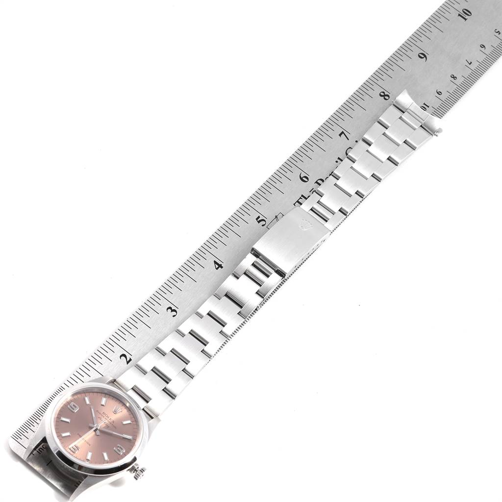 The image shows a flat lay view of the Rolex Air-King 14000 Men's Stainless Steel Pink Dial 14000 Men's Stainless Steel Pink Dial watch with its bracelet aligned next to a ruler.