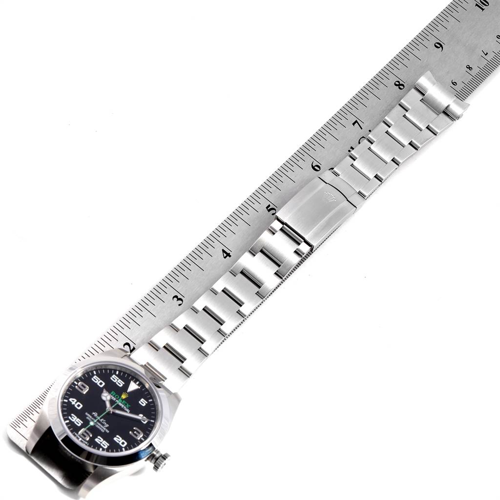 The image shows a Rolex Air-King 116900 Men's Stainless Steel Black Dial 116900 Men's Stainless Steel Black Dial watch laid flat next to a ruler, highlighting the metal bracelet and clasp.