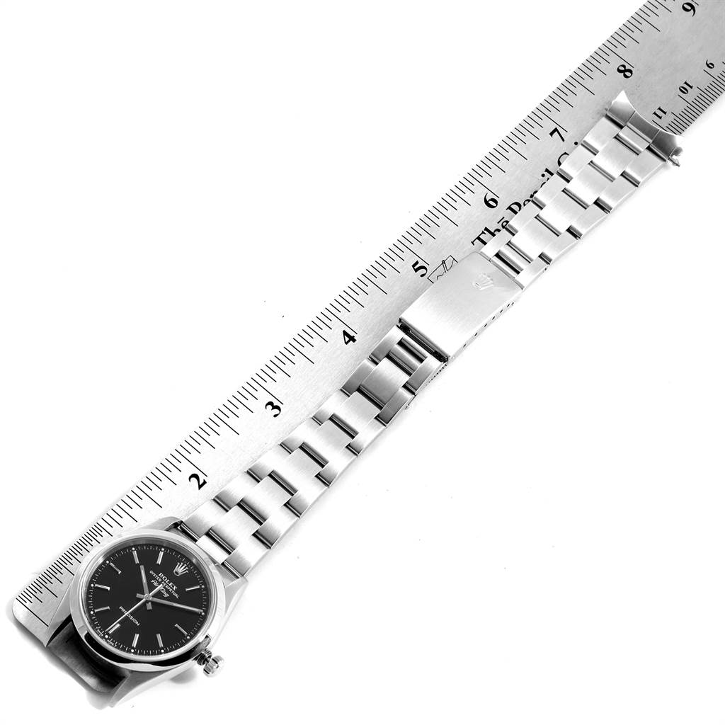 The image shows a top view of a Rolex Air-King 14000 Men's Stainless Steel Black Dial 14000 Men's Stainless Steel Black Dial watch, focusing on its band and clasp, measured against a ruler.