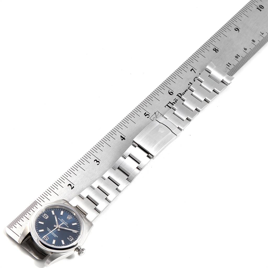 The image shows the Rolex Air-King 114200 Men's Stainless Steel Blue Dial 114200 Men's Stainless Steel Blue Dial watch measured alongside a ruler, displaying its face and metal bracelet.