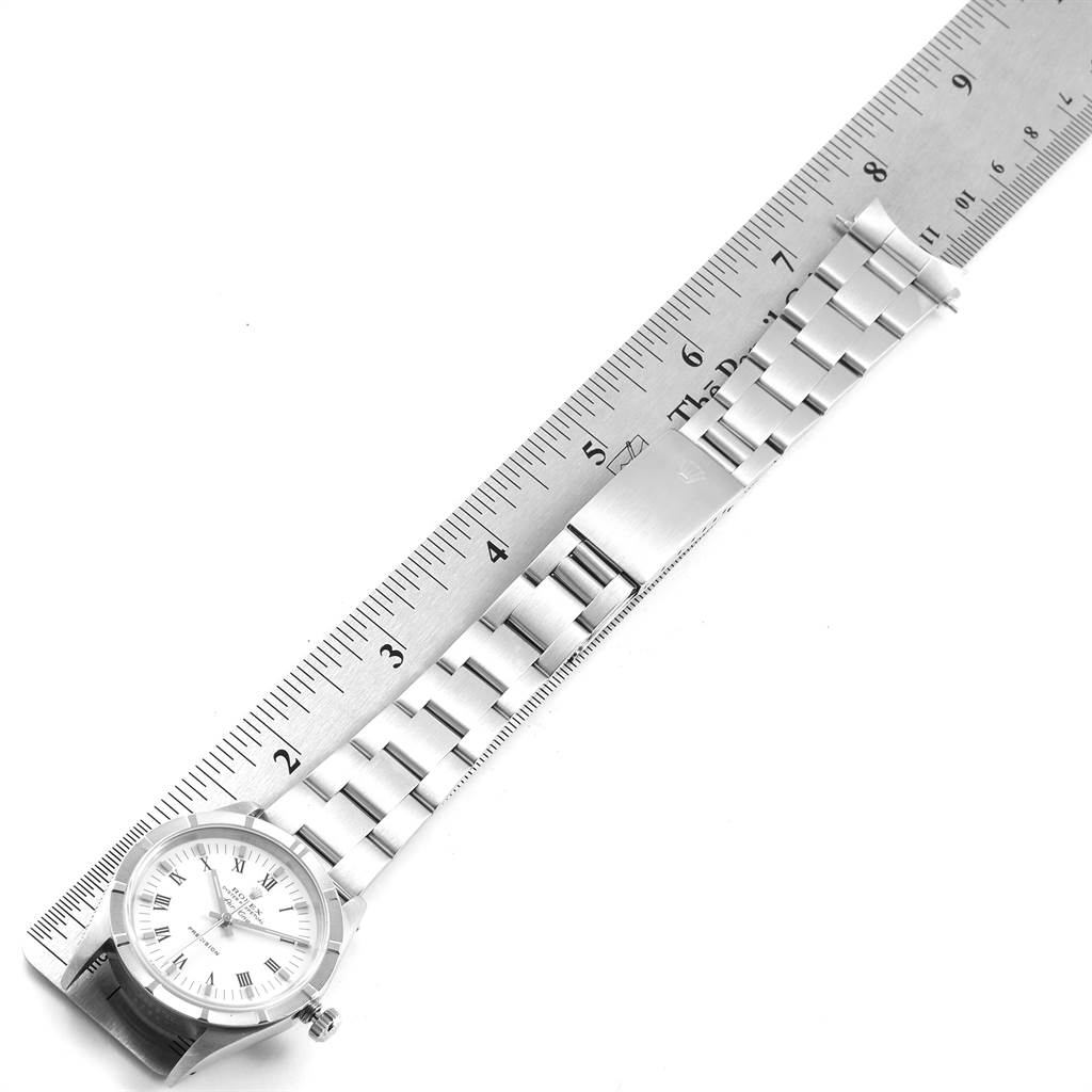 The image shows the Rolex Air-King 14010 Men's Stainless Steel White Dial 14010 Men's Stainless Steel White Dial watch placed beside a ruler, displaying its bracelet and dial from a top-down angle.
