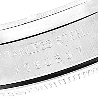 This image shows a close-up of the serial number and "STAINLESS STEEL" engraving on the side of a Rolex Air-King 14010 Men's Stainless Steel White Dial 14010 Men's Stainless Steel White Dial watch case.