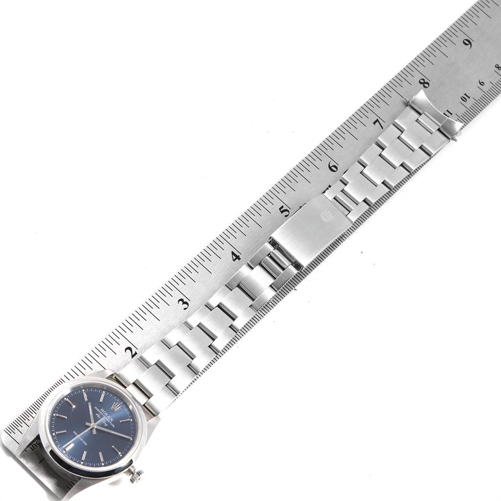 The image shows a Rolex Air-King 14000 Men's Stainless Steel Blue Dial 14000 Men's Stainless Steel Blue Dial watch and its bracelet laid flat along a ruler, showcasing the watch's face, bracelet links, and clasp.