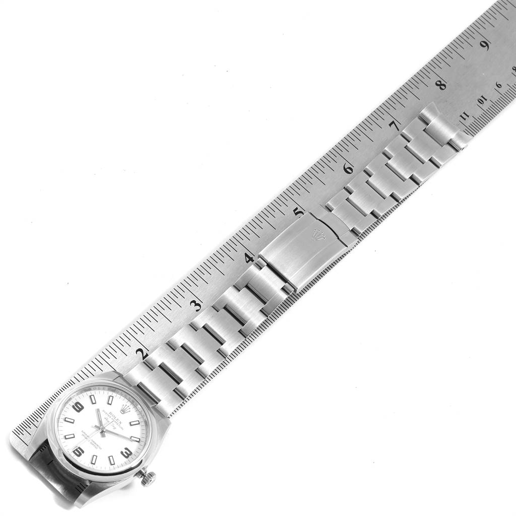 The image shows the front view of a Rolex Air-King 114200 Men's Stainless Steel White Dial 114200 Men's Stainless Steel White Dial watch with its metal bracelet against a ruler for size reference.