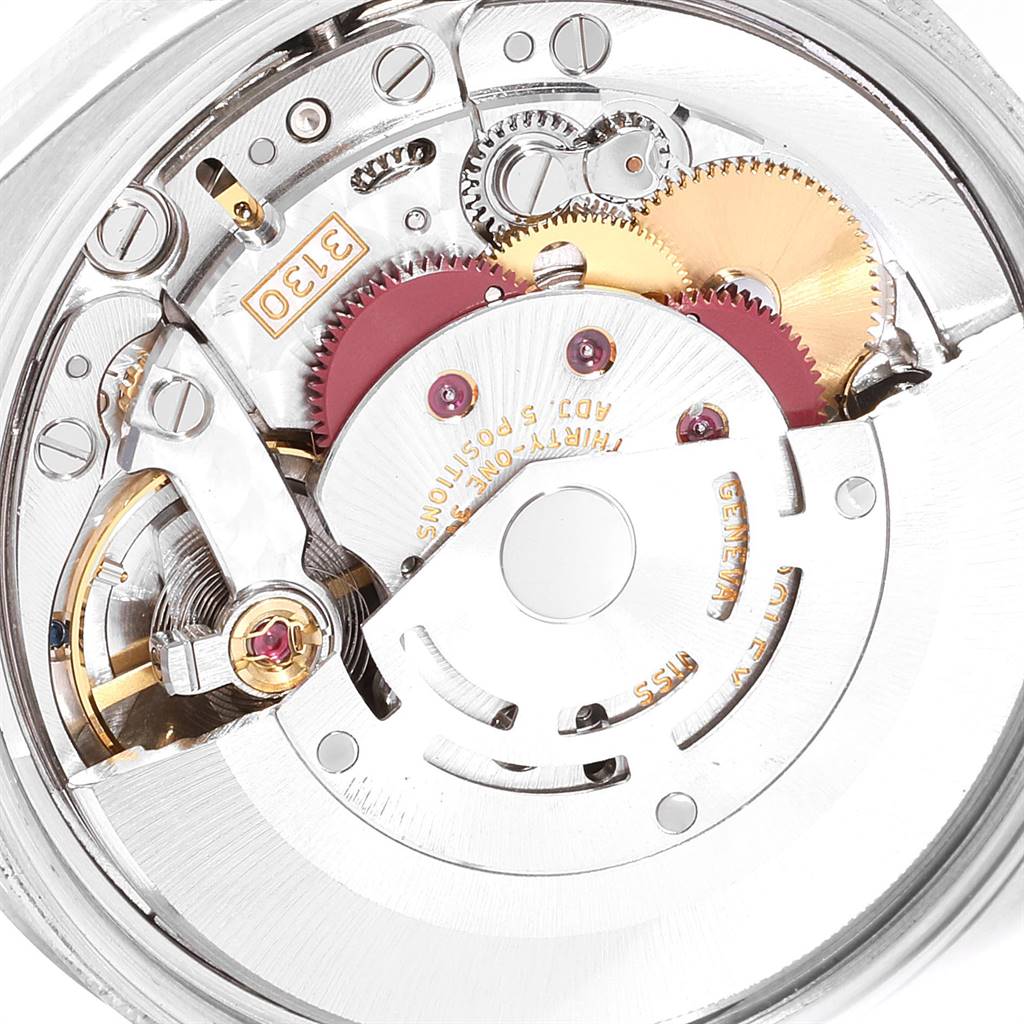 The image shows the internal mechanism of a Rolex Air-King 114200 Men's Stainless Steel White Dial 114200 Men's Stainless Steel White Dial watch, prominently featuring gears and the rotor for automatic movement.