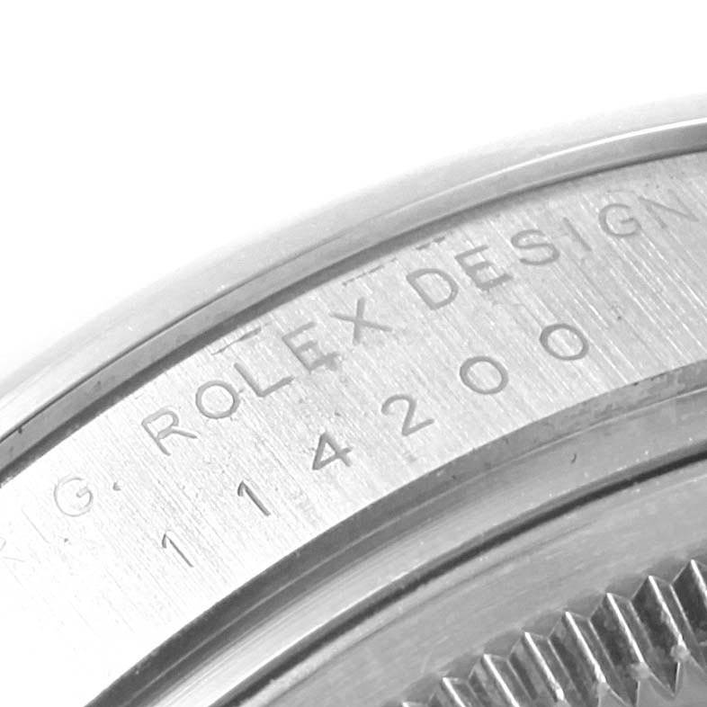 This close-up image shows the engraved case back of a Rolex Air-King 114200 Men's Stainless Steel Silver Dial 114200 Men's Stainless Steel Silver Dial watch model.