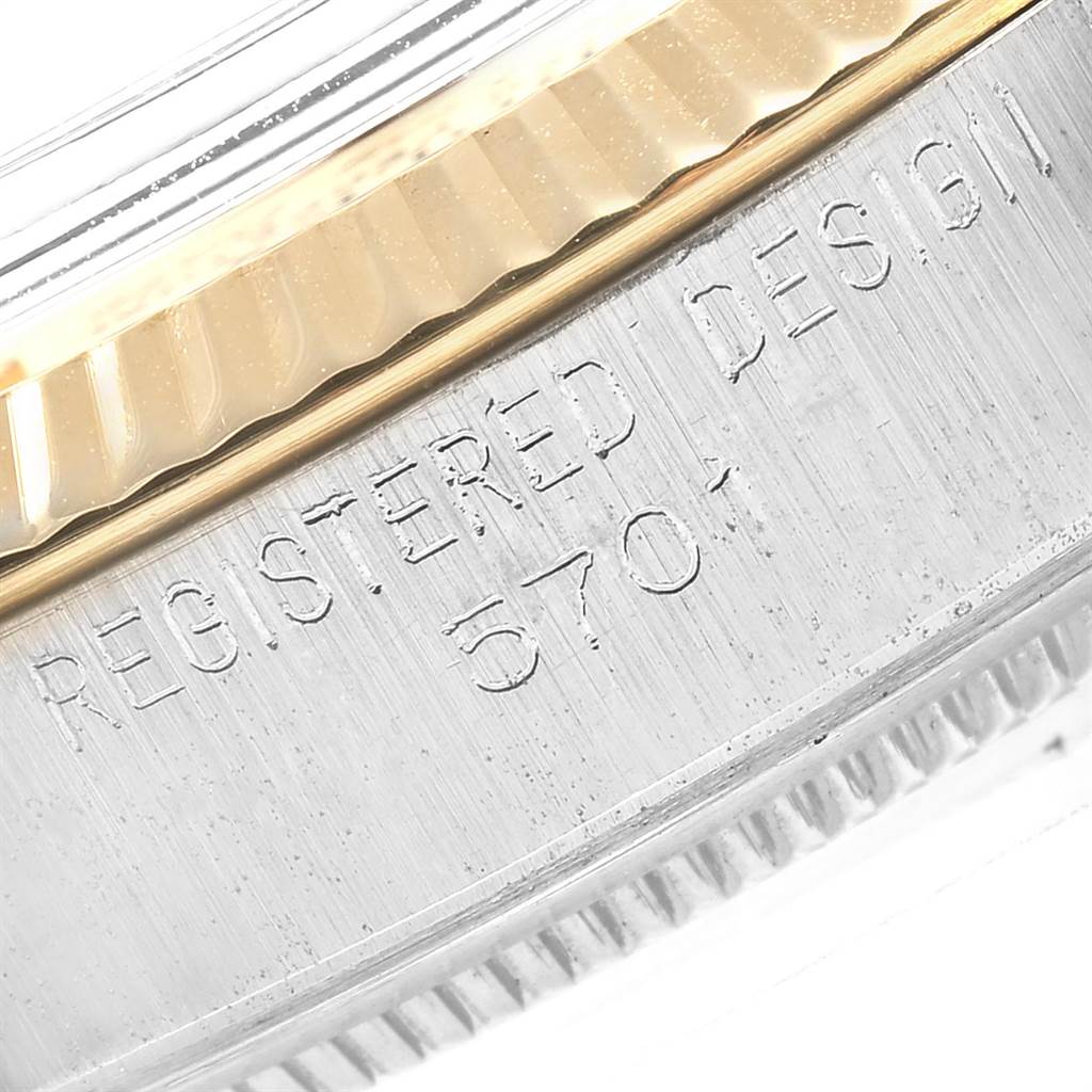This image shows a close-up of the engraved side of the bezel of a Rolex Vintage Collection 5701 Men's Steel and Gold (two tone) Silver Dial 5701 Men's Steel and Gold (two tone) Silver Dial model watch.