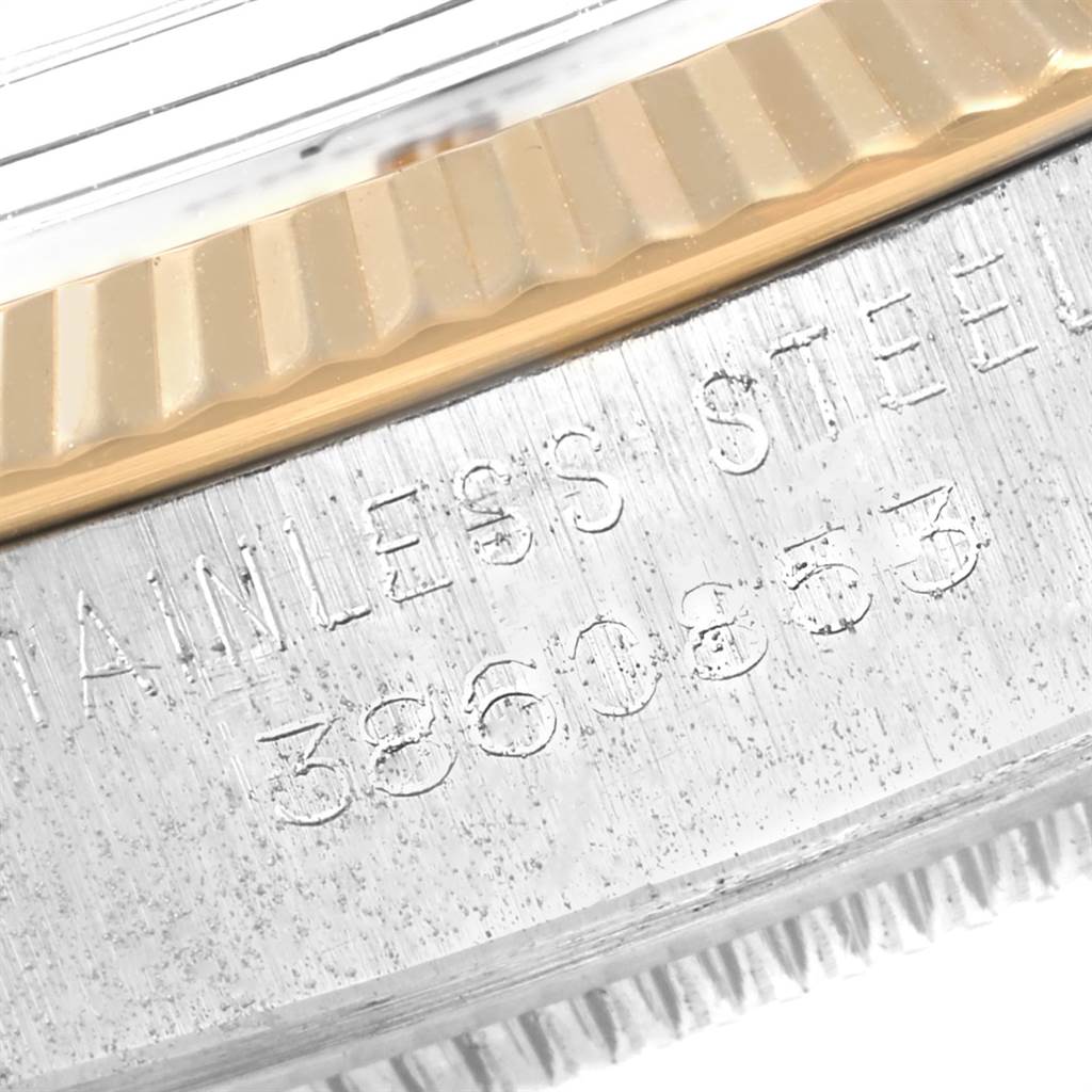 The image shows a close-up of the serial number and part of the bezel of the Rolex Vintage Collection 5701 Men's Steel and Gold (two tone) Silver Dial 5701 Men's Steel and Gold (two tone) Silver Dial model.