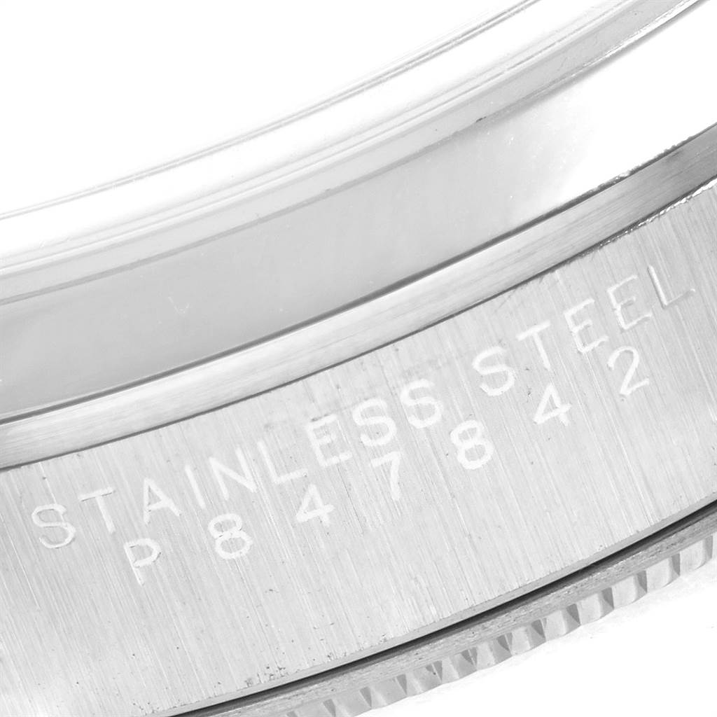 This image shows a close-up of the case back edge of the Rolex Air-King 14000 Men's Stainless Steel Black Dial 14000 Men's Stainless Steel Black Dial watch, with "STAINLESS STEEL" and a serial number engraved.