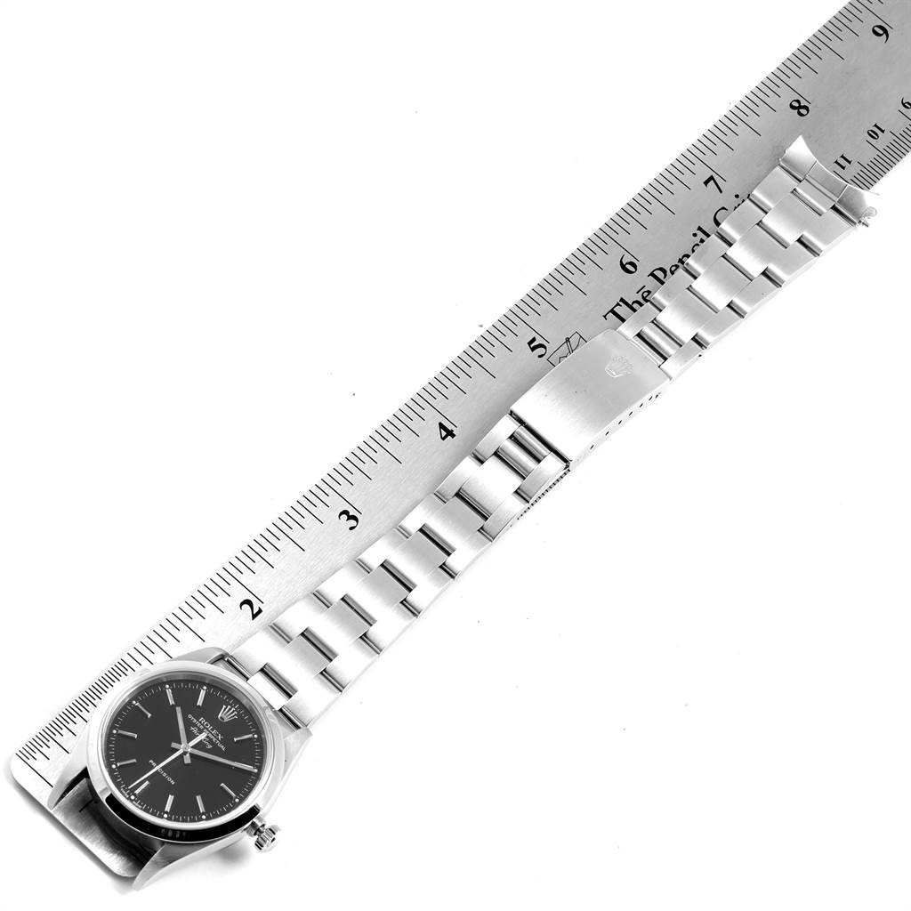 The image shows a top-down view of a Rolex Air-King 14000 Men's Stainless Steel Black Dial 14000 Men's Stainless Steel Black Dial watch and its metal strap, with a ruler for scale.