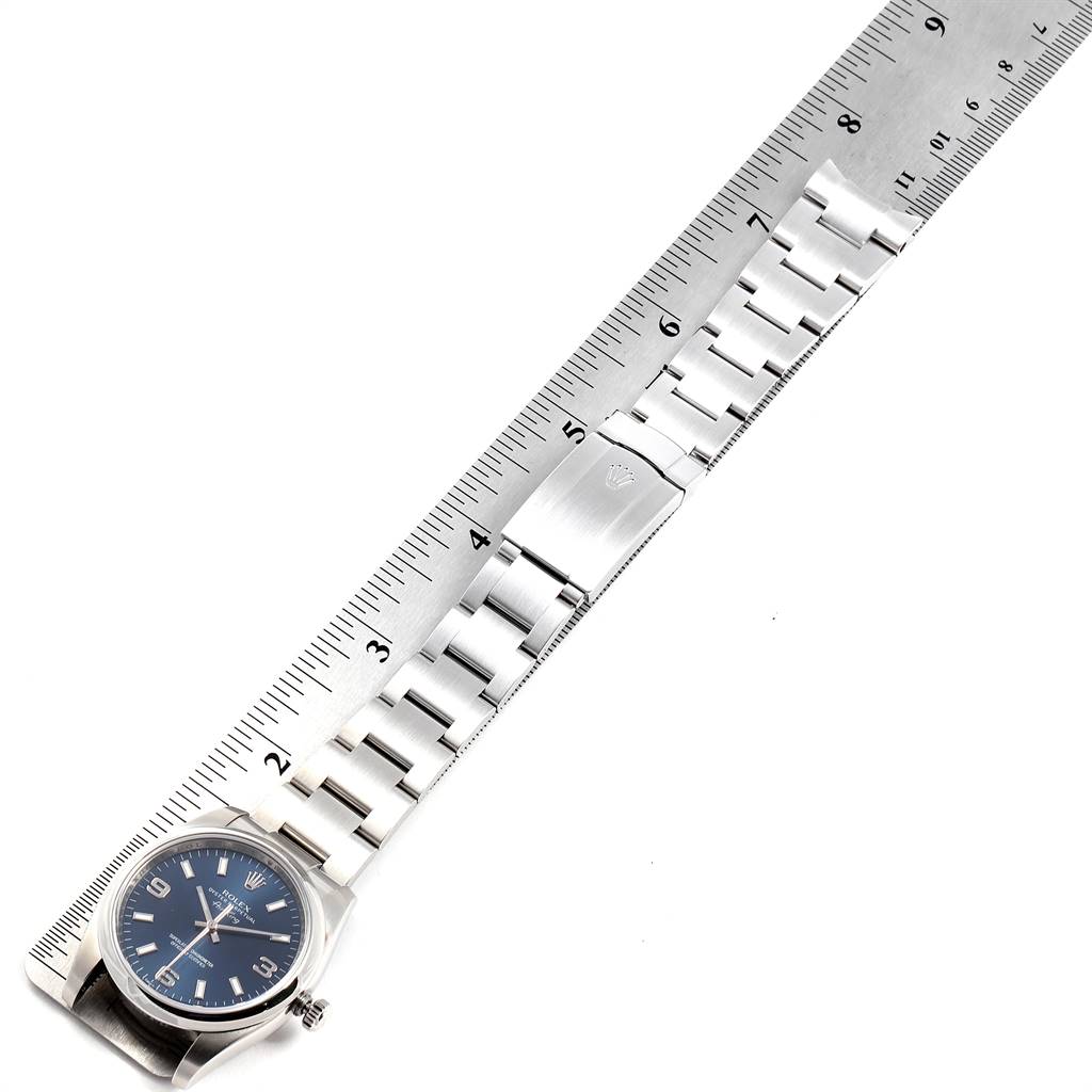The image shows a Rolex Air-King 114200 Men's Stainless Steel Blue Dial 114200 Men's Stainless Steel Blue Dial watch laid flat against a ruler, highlighting the bracelet and clasp.