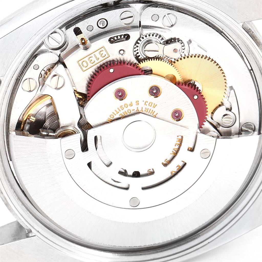 The image shows a close-up of the internal movement mechanism of a Rolex Air-King 114210 Men's Stainless Steel Silver Dial 114210 Men's Stainless Steel Silver Dial watch, focusing on gears and components.