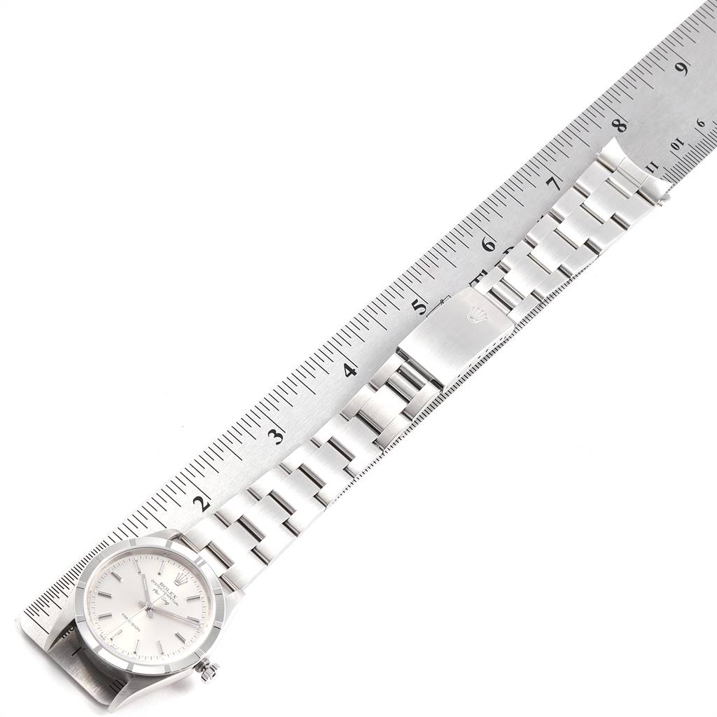 This image shows a Rolex Air-King 14010 Men's Stainless Steel Silver Dial 14010 Men's Stainless Steel Silver Dial watch laid flat with a metal band, alongside a ruler for size reference.