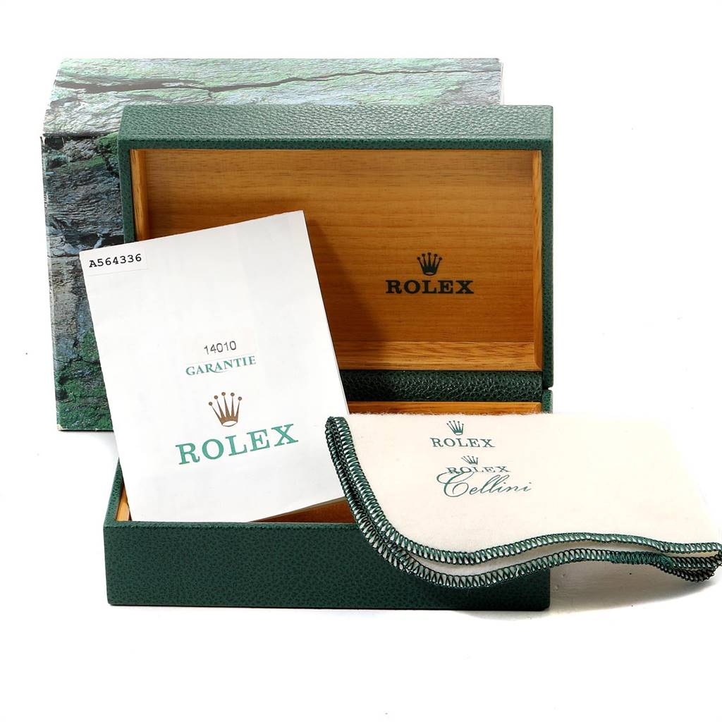 The image shows an open green Rolex box with warranty papers and a Rolex cleaning cloth for the Air-King model.
