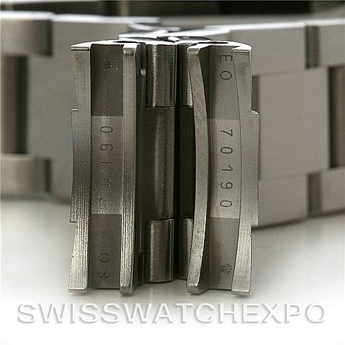 The image shows a close-up of the clasp of a Rolex Air-King 114200 Men's Stainless Steel Silver Dial 114200 Men's Stainless Steel Silver Dial watch, displaying part numbers engraved on the metal.