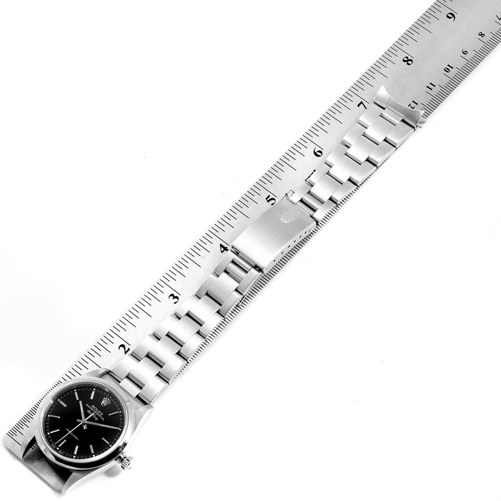The image shows a top-down view of the Rolex Air-King 14000 Men's Stainless Steel Black Dial 14000 Men's Stainless Steel Black Dial watch and its bracelet laid next to a ruler for measurement.