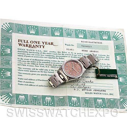 The image shows a Rolex Air-King 14010 Men's Stainless Steel Pink Dial 14010 Men's Stainless Steel Pink Dial watch, placed flat with its warranty card and green Rolex tag visible.