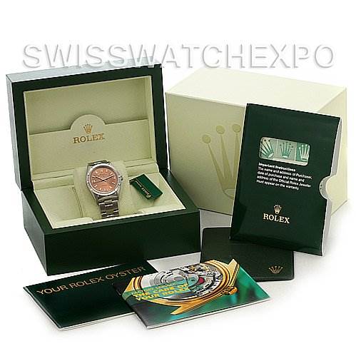 The image shows a Rolex Air-King 14010 Men's Stainless Steel Pink Dial 14010 Men's Stainless Steel Pink Dial watch from a front angle, along with its box, warranty card, and instruction booklets.