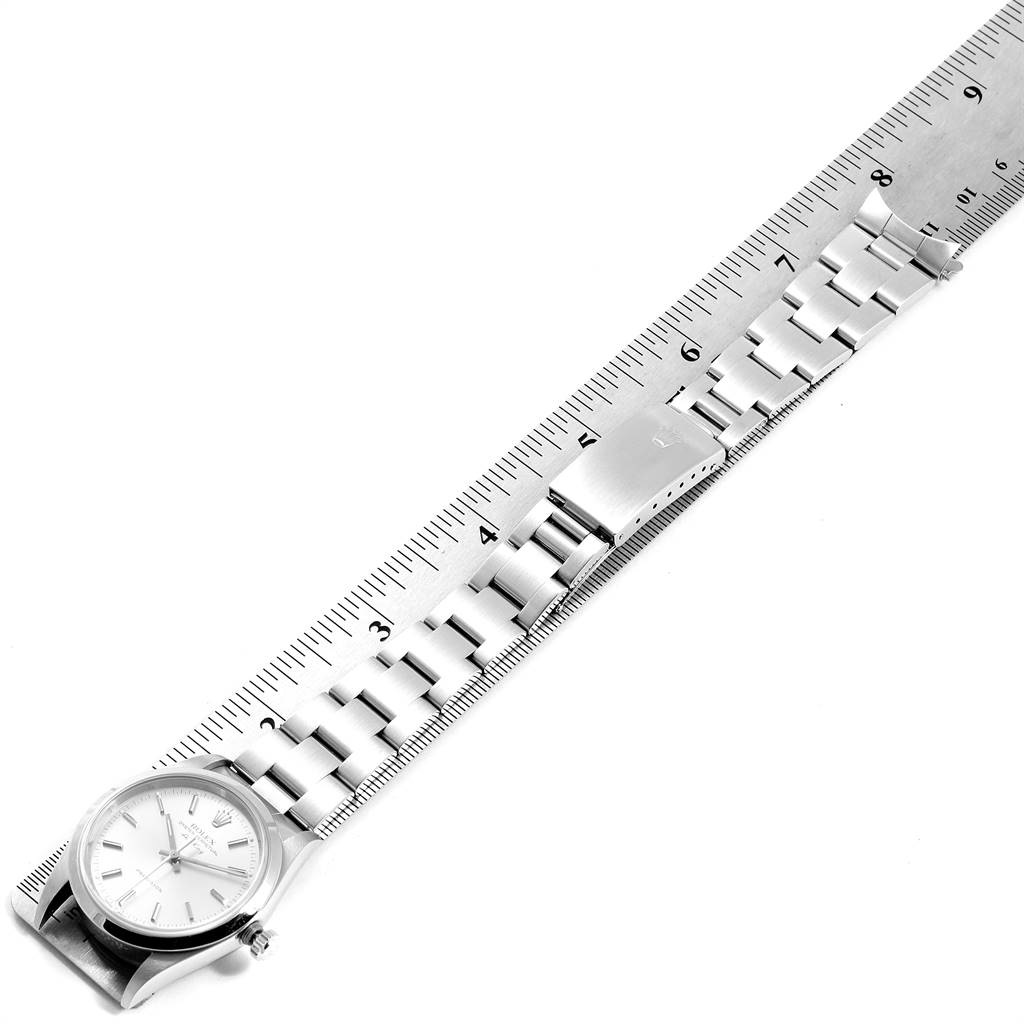 This image shows the Rolex Air-King 14000 Men's Stainless Steel Silver Dial 14000 Men's Stainless Steel Silver Dial model watch laid flat with a ruler measuring its length, displaying the face, case, and bracelet.