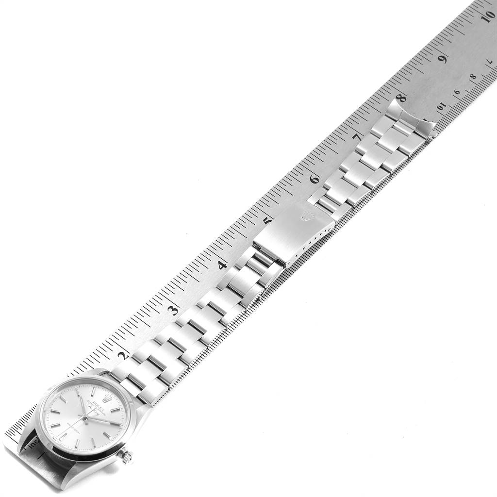 The image shows the Rolex Air-King 14000 Men's Stainless Steel Silver Dial 14000 Men's Stainless Steel Silver Dial watch laid flat alongside a ruler, displaying the face and metal bracelet.