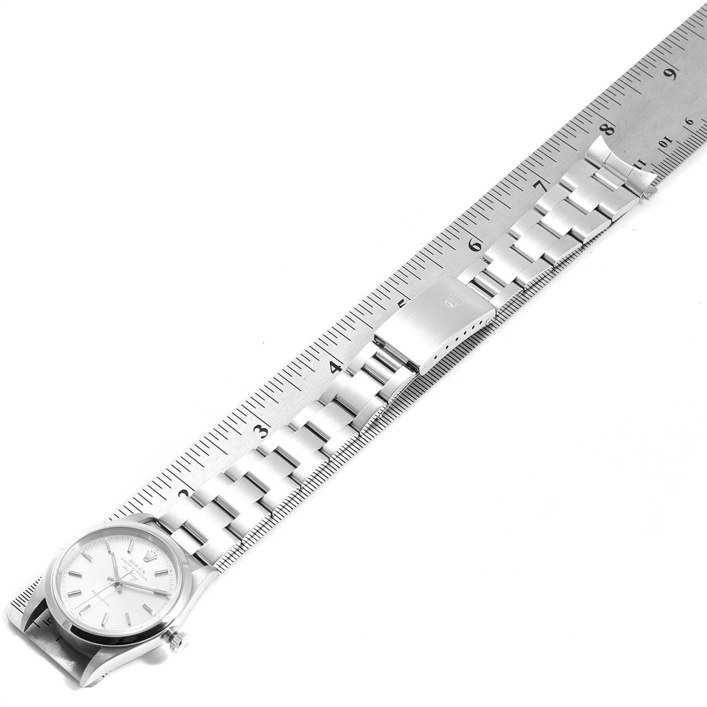 The image shows a top view of a Rolex Air-King 14000 Men's Stainless Steel Silver Dial 14000 Men's Stainless Steel Silver Dial watch, emphasizing its bracelet aligned with a ruler.