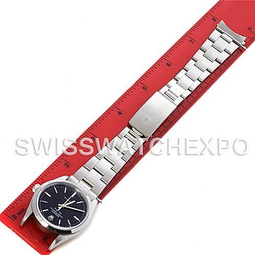 This image shows the Rolex Air-King 14000 Men's Stainless Steel Black Dial 14000 Men's Stainless Steel Black Dial watch laid flat, with its full bracelet and clasp visible, alongside a red ruler.