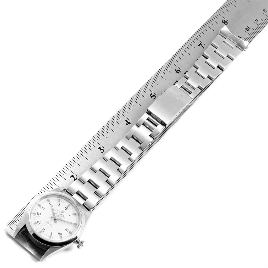 The image shows a Rolex Air-King 14000 Men's Stainless Steel White Dial 14000 Men's Stainless Steel White Dial watch positioned on a ruler, displaying its bracelet and clasp.