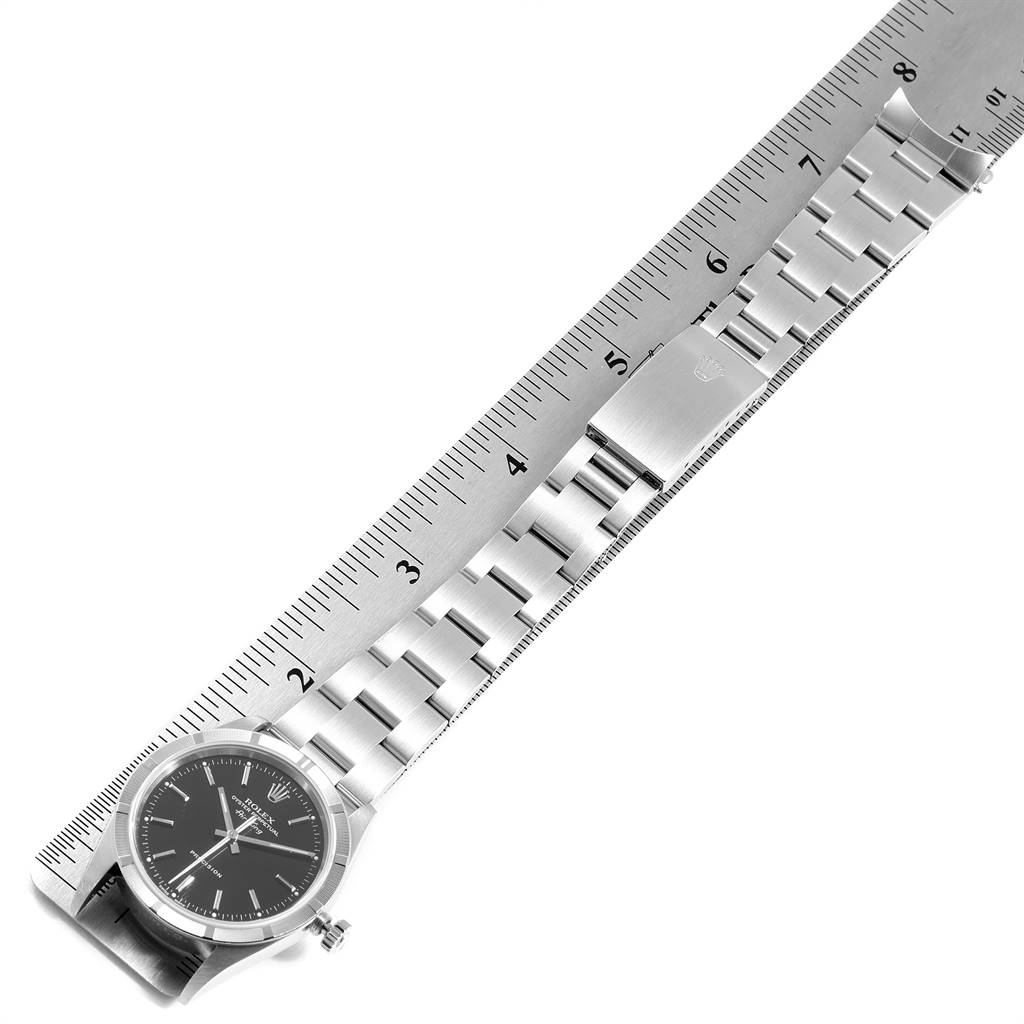 The image shows a Rolex Air-King 14010 Men's Stainless Steel Black Dial 14010 Men's Stainless Steel Black Dial watch laid flat against a ruler, displaying the face, bezel, crown, and metal bracelet.