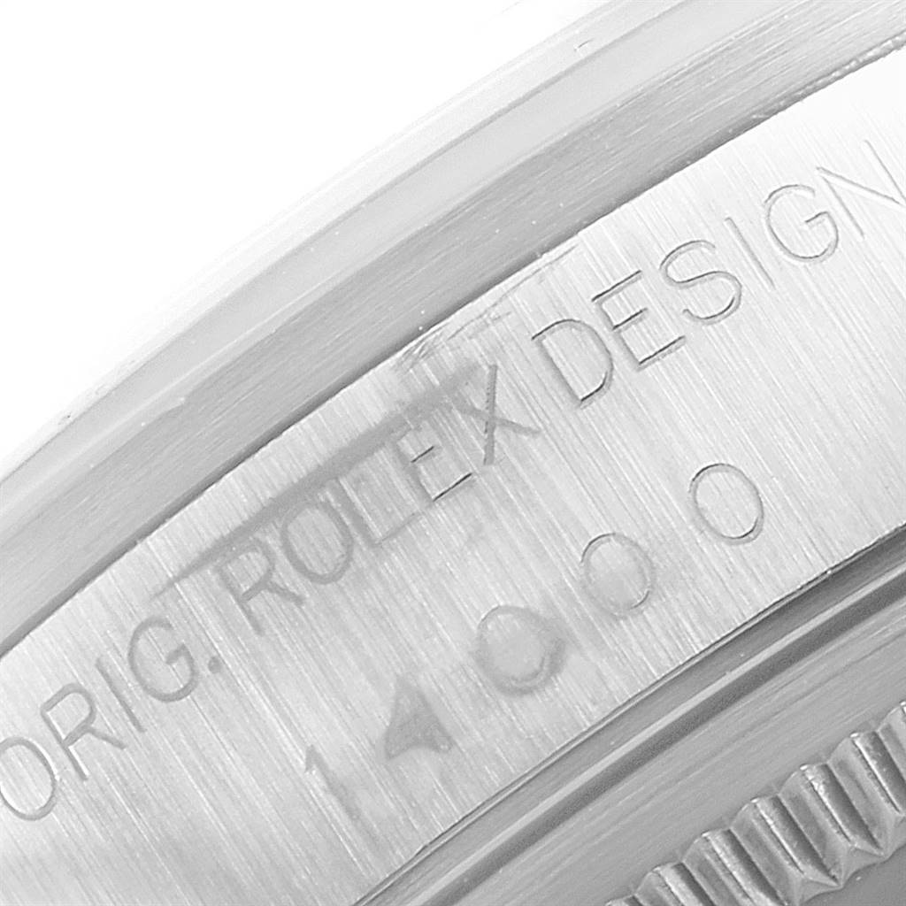 This close-up image of the Rolex Air-King 14000 Men's Stainless Steel Black Dial 14000 Men's Stainless Steel Black Dial watch focuses on the engraved text along the edge of the bezel.