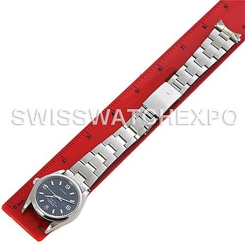 The Rolex Air-King 14000M Men's Stainless Steel Blue Dial 14000M Men's Stainless Steel Blue Dial watch is shown from a top-down angle, displaying its full bracelet and face next to a red ruler.