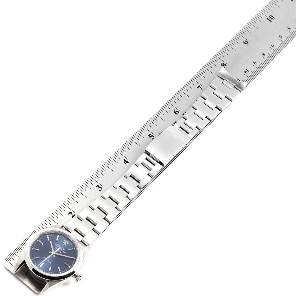 The image shows a side view of a Rolex Air-King 14000 Men's Stainless Steel Blue Dial 14000 Men's Stainless Steel Blue Dial watch laid against a ruler, displaying its full metal bracelet and clasp.
