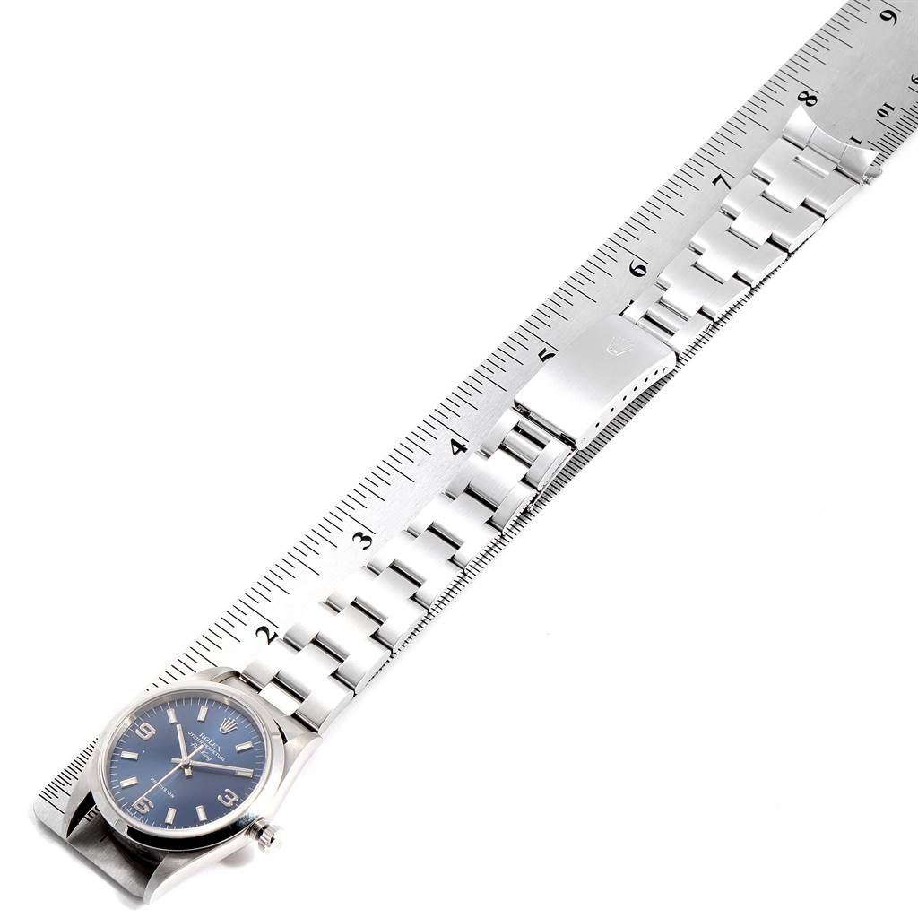 This image shows a Rolex Air-King 14000 Men's Stainless Steel Blue Dial 14000 Men's Stainless Steel Blue Dial watch laid flat next to a measuring ruler, highlighting its bracelet and clasp.