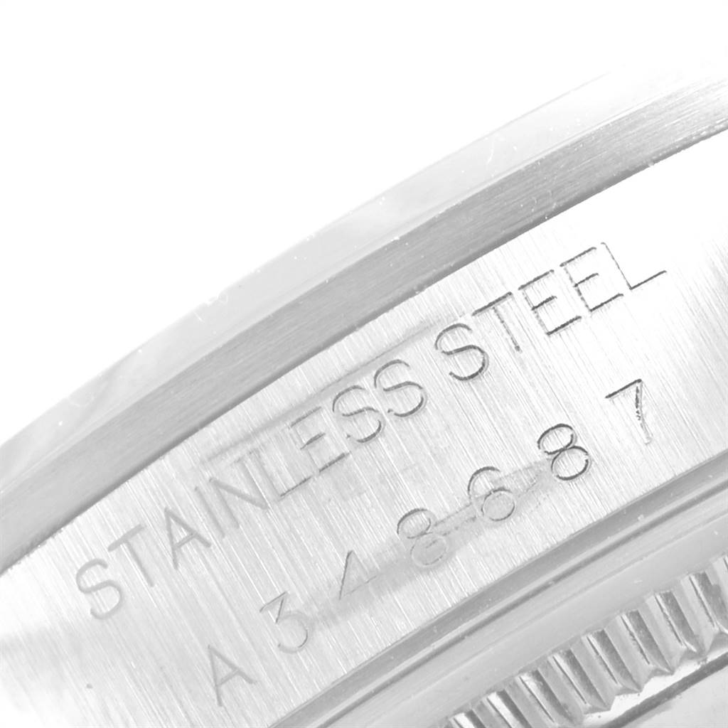 The image shows an engraved section of a Rolex Air-King 14000 Men's Stainless Steel Blue Dial 14000 Men's Stainless Steel Blue Dial watch displaying "STAINLESS STEEL" and a reference number.