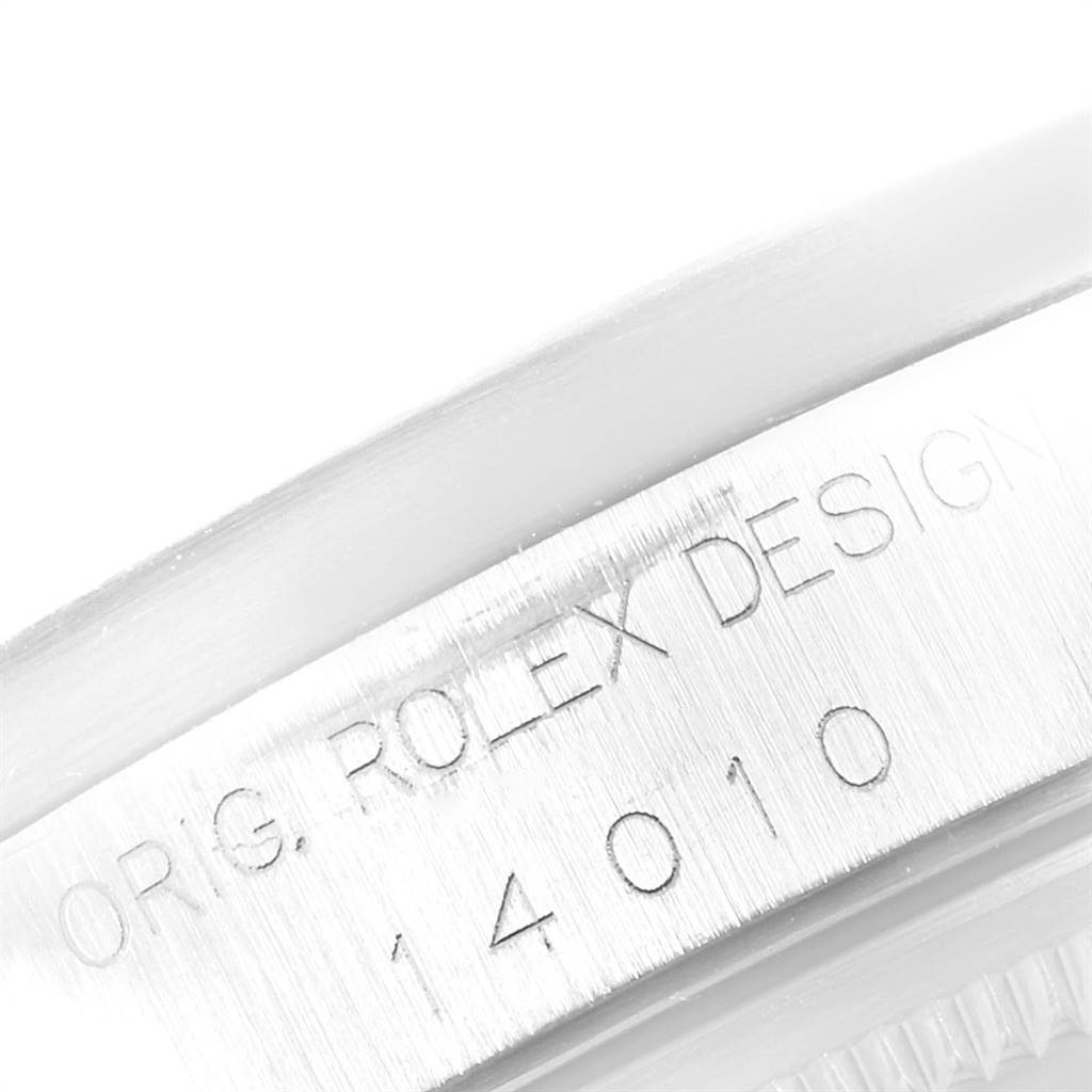 This close-up angle shows the engraved edge of the Rolex Air-King 14010 Men's Stainless Steel White Dial 14010 Men's Stainless Steel White Dial model, highlighting the "Rolex Design" inscription and model number 14010.