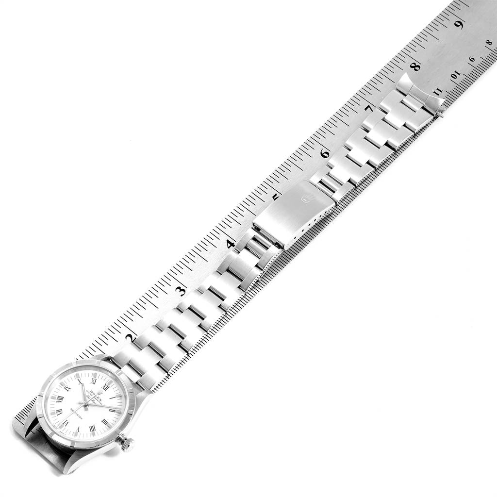 The image shows a Rolex Air-King 14010 Men's Stainless Steel White Dial 14010 Men's Stainless Steel White Dial watch placed next to a ruler, highlighting its band and clasp from a top-down view.